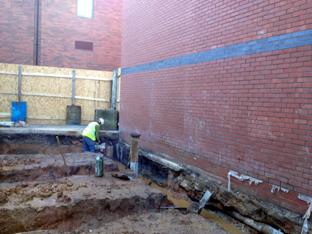 Foundation trench along hotel wall